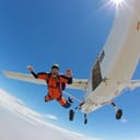 Skydiver jumping from an airplane at high altitude