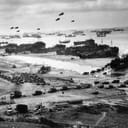 Landing ships offload cargo at Omaha Beach at low tide, in the initial phase of the Allied invasion of Normandy, mid-June 1944.