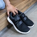 A person taking a pair of shoes