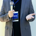 Journalist with a press pass and a microphone