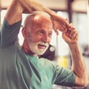 a close-up of a senior man working out at the gym
