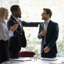 team applauding and celebrating a coworker's success during a meeting