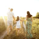 A family walking down a field road
