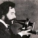 an actor portraying Alexander Graham Bell in a 1926 movie, holding Bell's original telephone transmitter