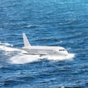 Emergency landing of the airplane on water with splashes. Concept of aircraft rescue, flight safety.