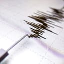 Richter scale Low and High Earthquake Waves with Vibration on white paper background, audio wave diagram concept, photo of cellphone screen, Aceh Indonesia