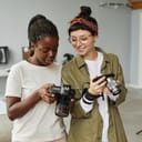 Two female photographers discuss a photo