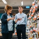 female supermarket manager providing training to a new male employee