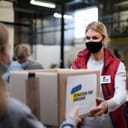 Volunteers handing out aid supplies to Ukrainian migrants