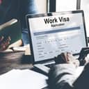 a man applying for work visa using his laptop