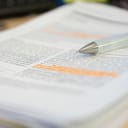 A pencil rests atop a reviewed scientific journal article.