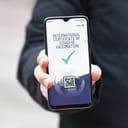 Concept for international Corona virus vaccine passport on mobile phone device to allow vaccinated people privileges