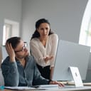 woman boss pointing at an employee's work