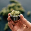 A person holding marijuana in a dispenser