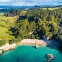 Aerial view of a secluded coastline with tiny bays in Coromandel, New Zealand.