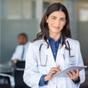 a portrait of a young female doctor holding a tablet
