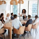 businesswoman standing and speaking at a boardroom meeting in a modern office setting