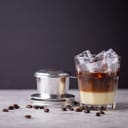 Vietnamese iced coffee with condensed milk in black background