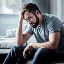 A depressed man sitting at his house