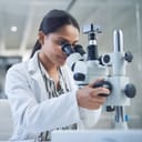 Science, microscope and innovation with a woman in a laboratory for medical research or experiment. Healthcare, medicine and a young indian engineer working in a lab for pharmaceutical development