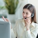 smiling female customer support phone operator at her workplace