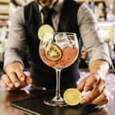 Expert barman is making cocktail at night club