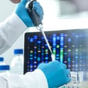 Scientist using a pipette to transfer a sample into a vial for DNA testing