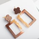 close-up of a brown and gold handmade resin earrings