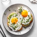 A breakfast plate with two egg sandwiches