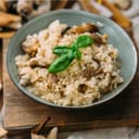 Bowl of risotto with mushrooms and fresh basil