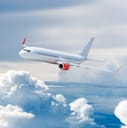 Passenger airplane flying above the clouds