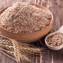 Wheat bran in wooden bowl and ears of wheat on a wooden table