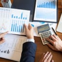 Closeup of two people reviewing financial charts