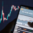 Smartphone with mobile application cryptocurrency wallet. A man analyzes the price chart for bitcoin in a mobile application. The concept of cryptocurrency trading