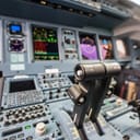 a close-up of engine power control and other flight control units in the cockpit of a modern passenger airplane