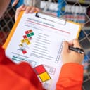 close-up of a worker reviewing a hazardous chemical information form in a factory