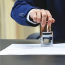 Man about to stamp a document