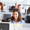 A smiling young woman working in a call center