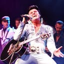 Elvis Presley impersonator singing on stage