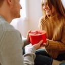 Exchange of gifts. Young couple at home celebrating Valentine's Day. 