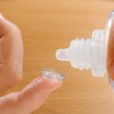 Contact lense being rinsed with solution