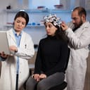 Doctors measuring patient's neural activity