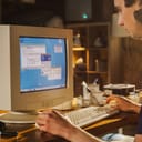 male college student surfing the internet on an old desktop computer from 1990s
