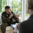 Soldier wearing uniform attending a therapy session