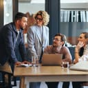 team of four people engaged in a meeting in the office of a digital marketing agency