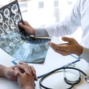 Closeup of a MRI scan being interpreted by a doctor to their patient