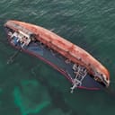 Overhead view of a capsized boat in water