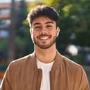 Young hispanic man smiling confident standing at park