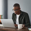 close-up of a businessman typing on a laptop in an office