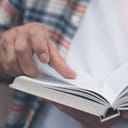 Man skimming through an open book